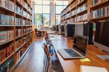 library book stacks with tables and computers generated by Adobe Firefly